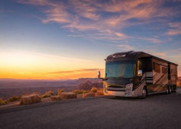 Big-rig RV at a Southwest mesa overlook at sunset